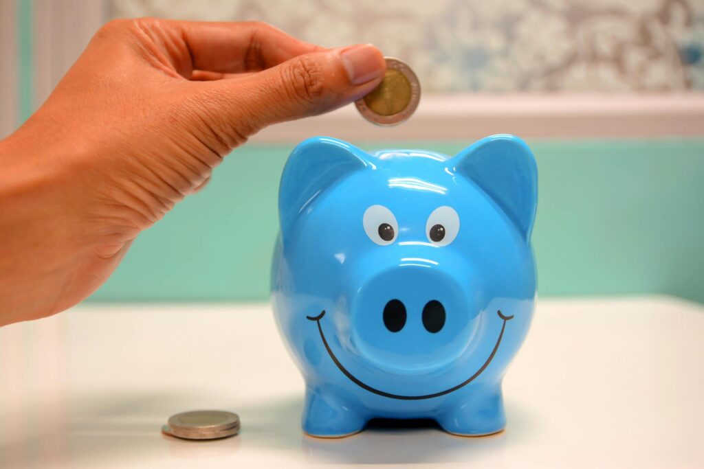 Putting money in a blue piggy bank